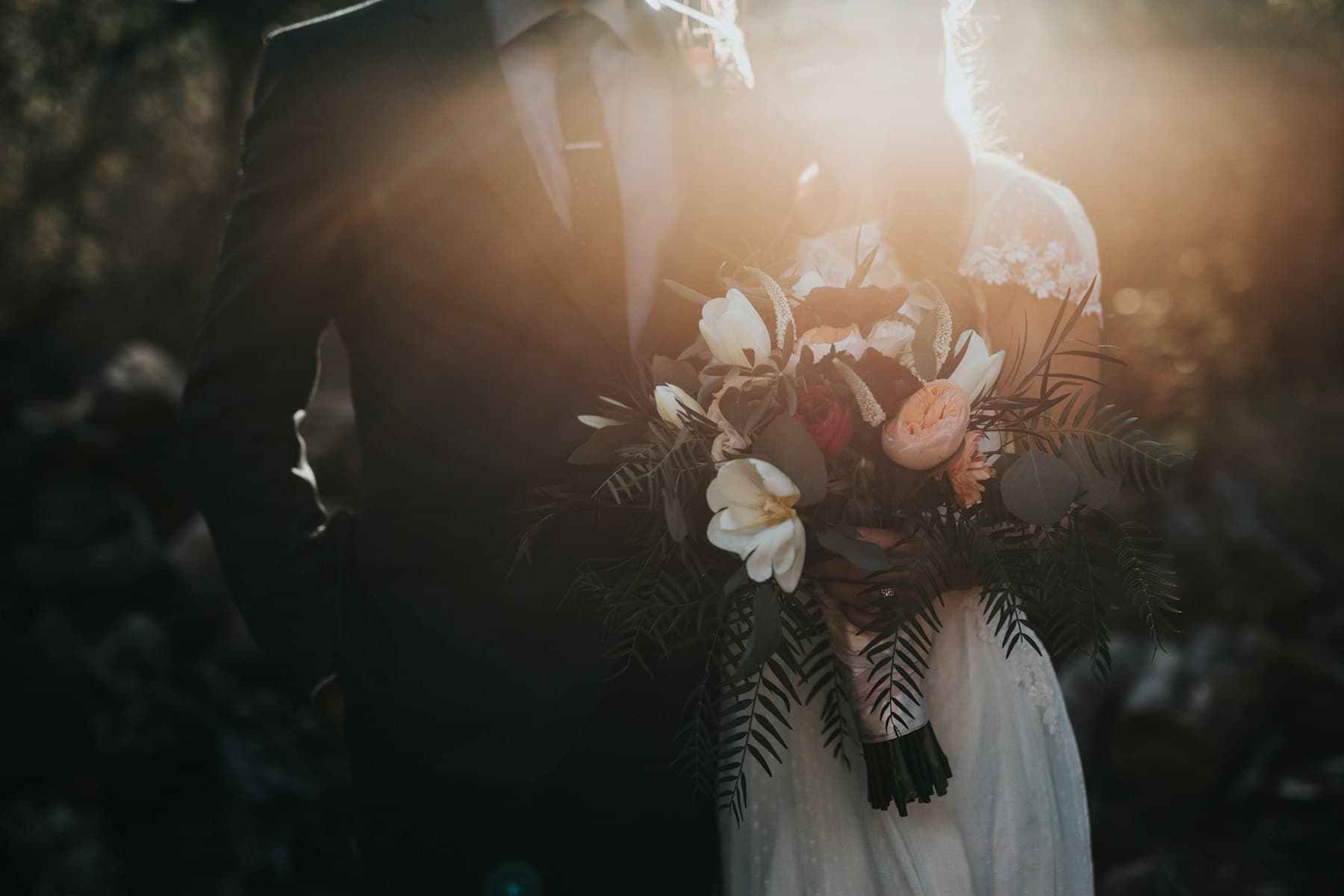 Bride and groom embracing at sunset